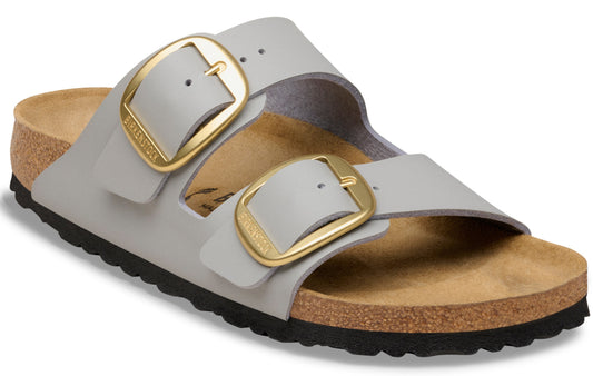 Two-strap sandal with oversized gold buckles and a cork footbed.