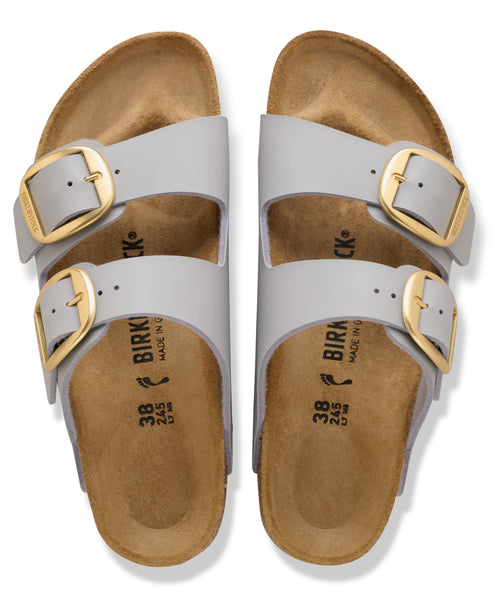 Two gray sandals with wide straps and gold buckles displaying the text "BIRK" on the footbed.