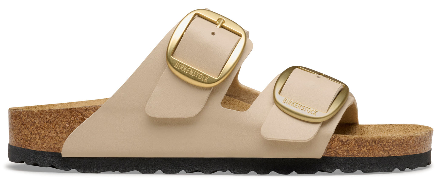 Two strap beige sandal with golden buckles.