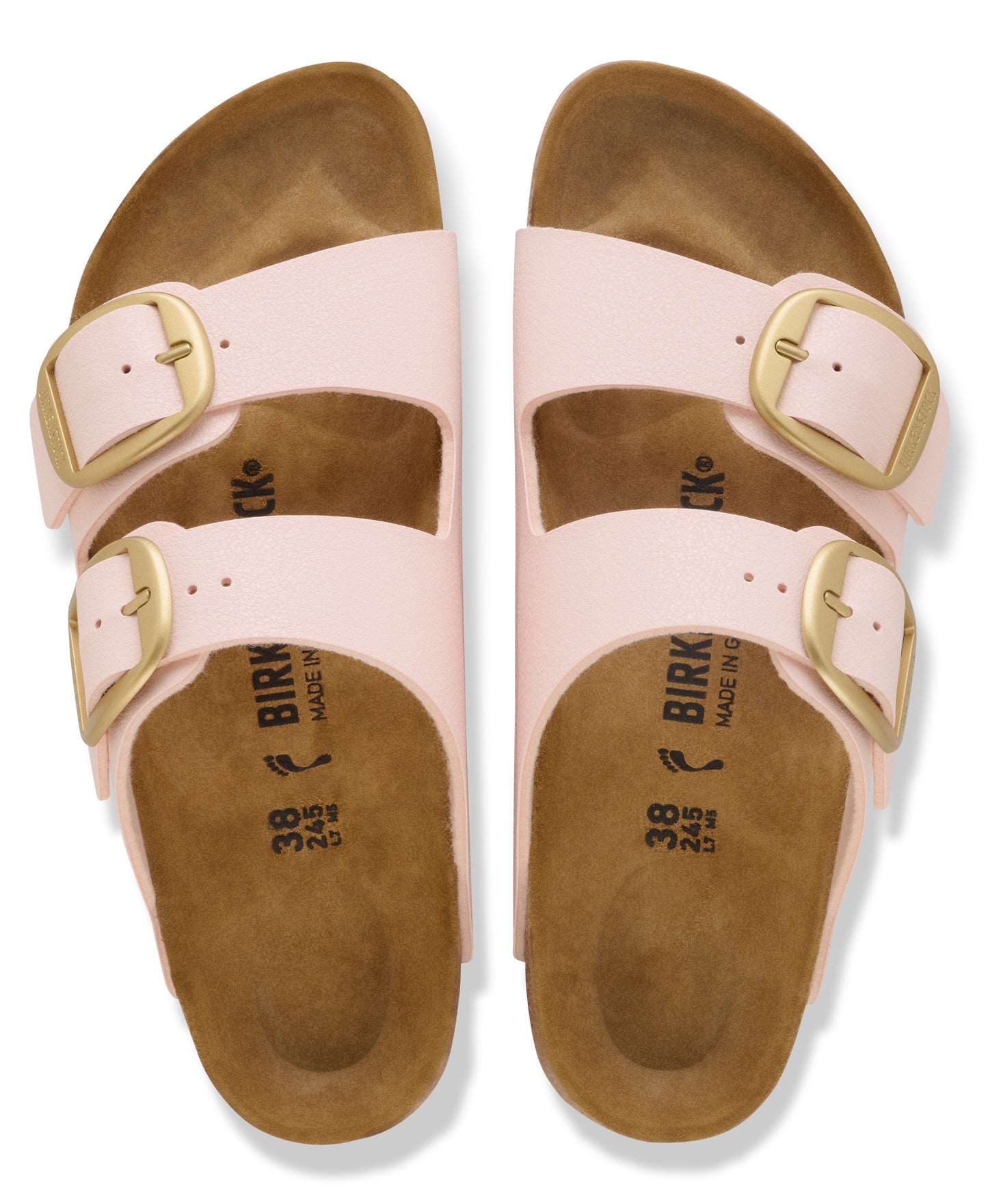 A pair of pink two-strap sandals with large gold buckles and brown footbeds.