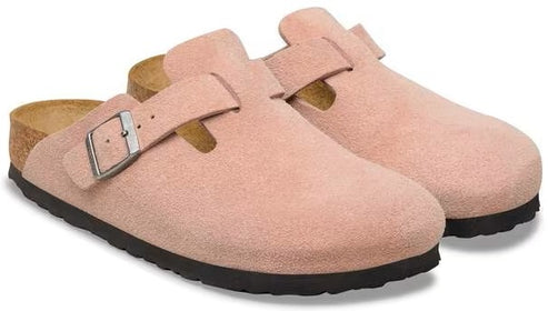 Pair of pink suede clogs with buckle, cork sole, and black outsole.