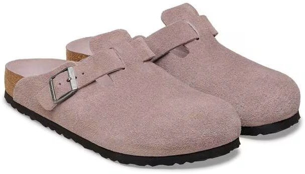 Pair of light pink suede clogs with adjustable buckle strap and black soles.