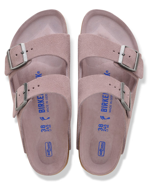 Top-down view of two mauve suede sandals, each with two adjustable buckle straps and a size marking on the footbed.