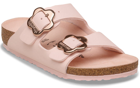 Pink sandal with two straps and flower-shaped buckles.