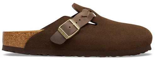 A brown suede leather clog with a cork footbed and an adjustable strap across the top secured by a gold-tone metal buckle.