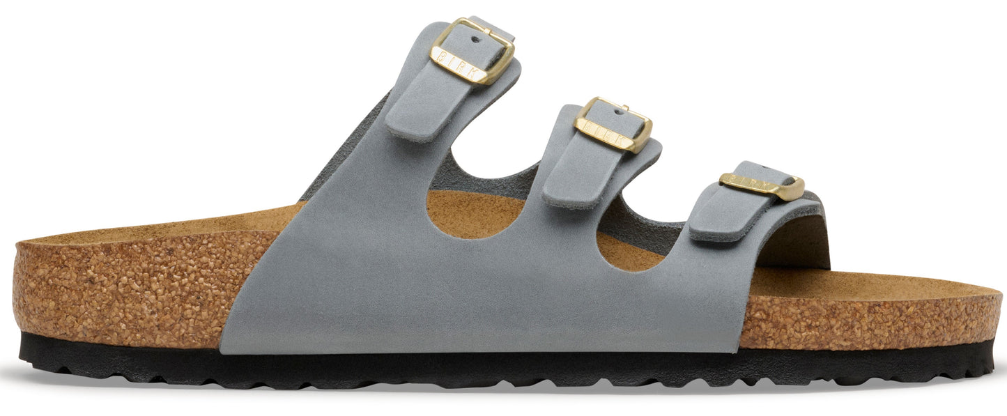 A gray sandal with three straps and gold buckles.