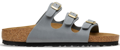 A gray sandal with three straps and gold buckles.