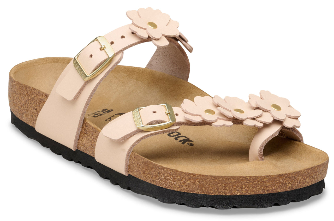 Light pink leather sandal with flower decorations and gold buckles.