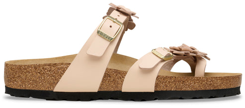 Pale pink sandals with flower details and buckle straps.