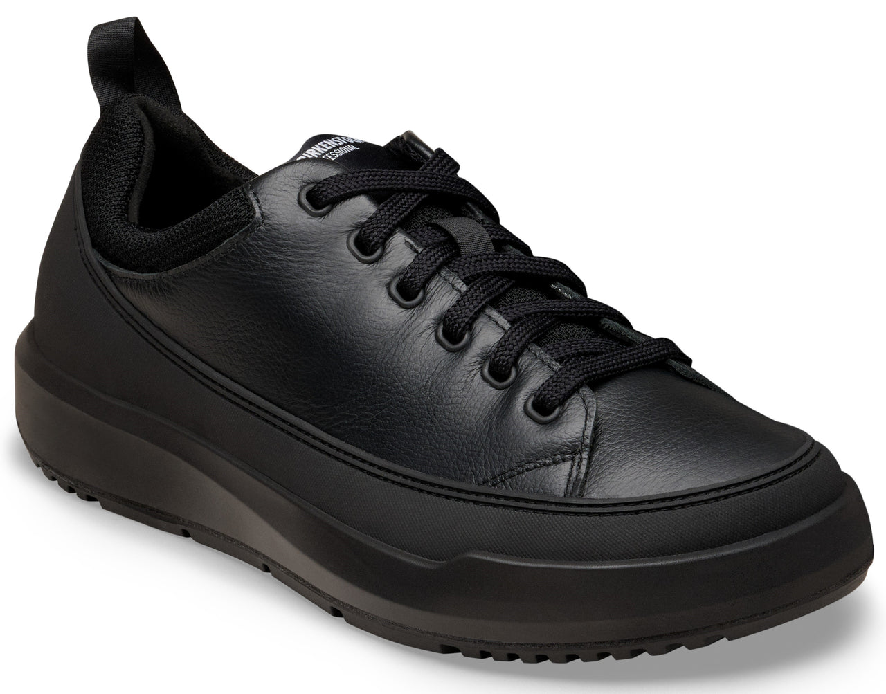 A black leather low-top sneaker featuring a thick platform sole, black laces, a padded collar, and a pull tab at the heel.