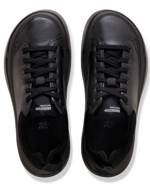 A pair of black, rounded-toe lace-up shoes seen from above, featuring leather and fabric construction with the text Birkenstock Professional on the tongues and the size 36 printed on the insoles.