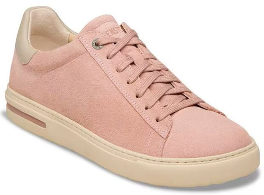 Pink suede sneaker with cream colored sole and gold heel.