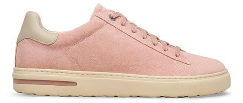 A pink suede sneaker with off-white sole.