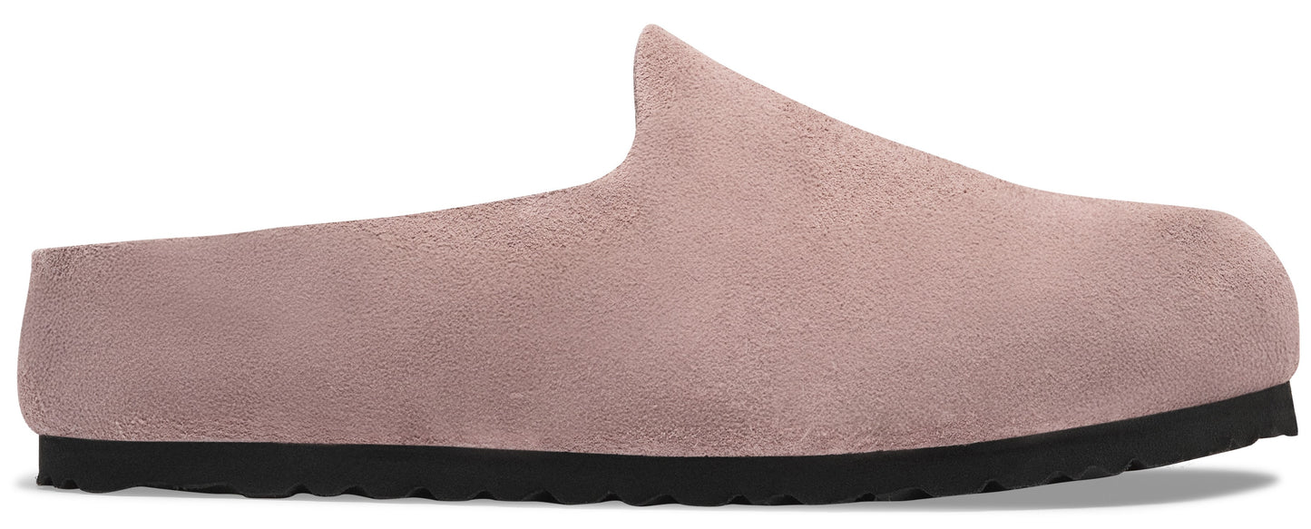 A minimalist, dusty rose suede slip-on mule shoe with a simple, rounded closed toe and a flat, thick black rubber sole.
