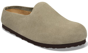 A slip-on clog made of light taupe suede with a dark brown, textured rubber sole.