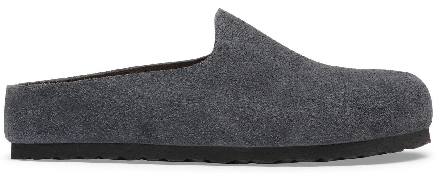 A minimalist dark grey suede mule slip-on shoe with a thick black textured rubber sole.