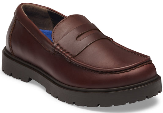 A brown leather penny loafer shoe featuring a thick, dark brown lugged rubber sole and a blue insole.