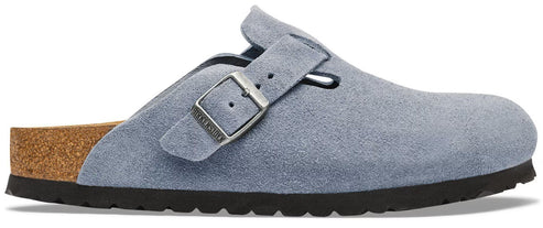 A light blue suede Boston style clog with an adjustable metallic buckle strap, a cork footbed, and a thick black serrated rubber sole.