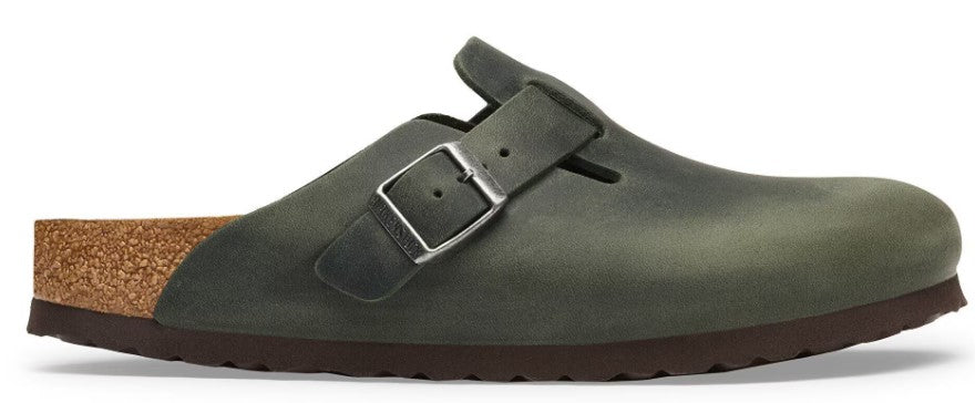 A slip-on shoe with an olive-green leather upper, a silver buckle strap, a contoured cork footbed, and a dark brown textured rubber sole, shown from a side profile.