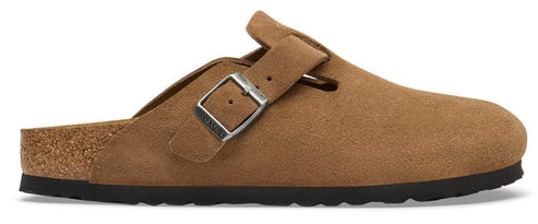 A tan suede slip-on clog with an adjustable metallic buckle strap, a contoured cork midsole, and a black textured rubber outsole.