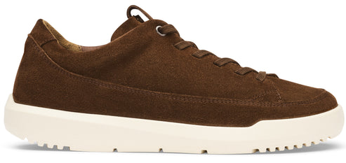 A brown suede low-top sneaker with a thick, white, textured rubber sole.