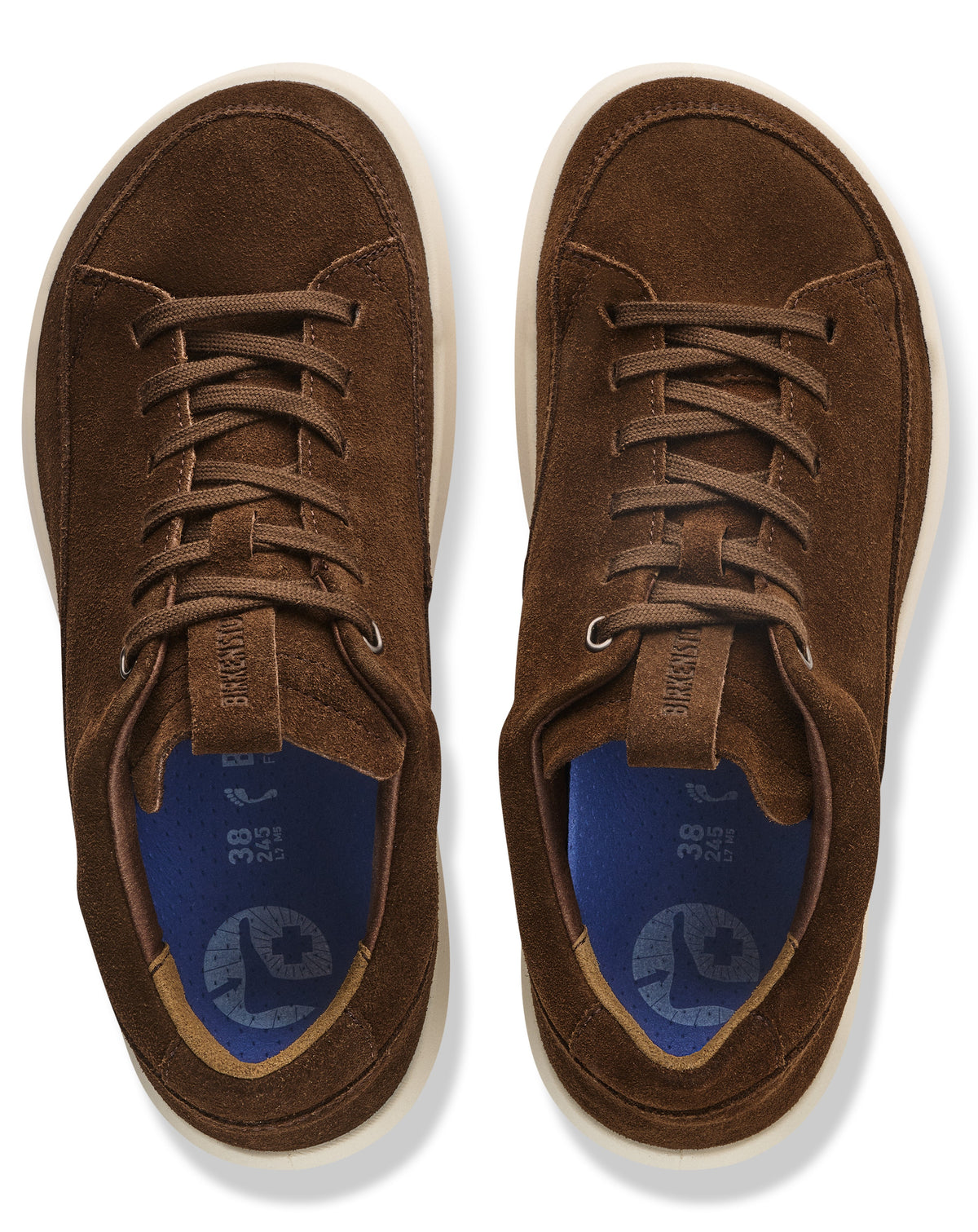 A pair of brown suede sneakers seen from a top-down view with dark blue insoles featuring a foot-shaped icon, size 38 markings, and light-colored soles.