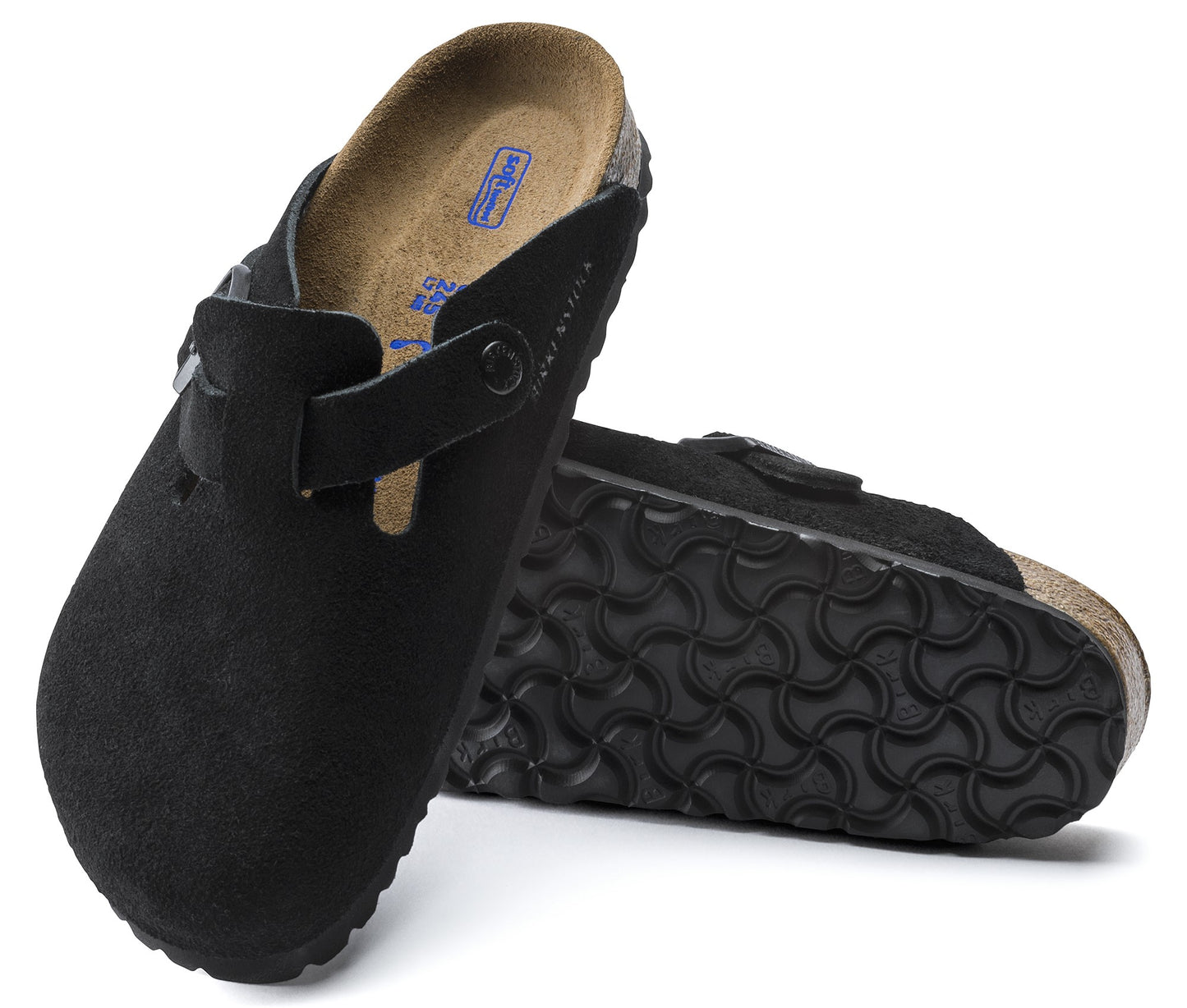 Two black clog-style sandals, one upright showing the side and interior, and the other on its side showing the patterned sole.