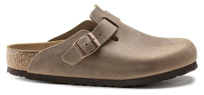 Taupe clog shoe with a buckle strap.