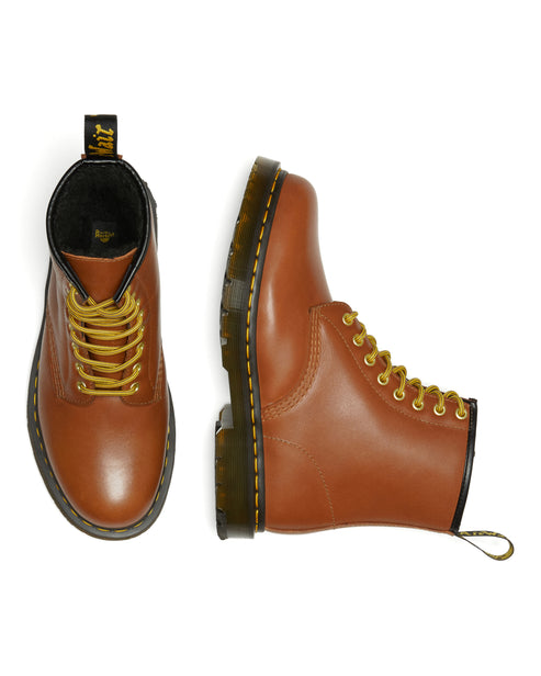 Pair of brown leather boots with yellow laces.