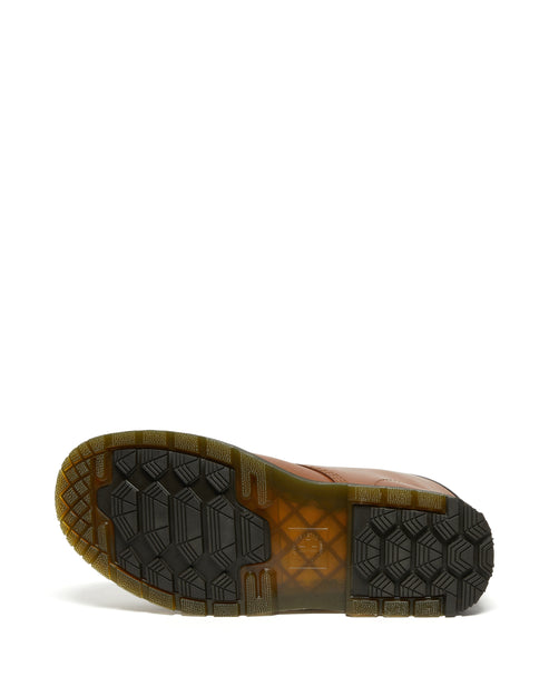 Brown shoe sole with black hexagonal treads.