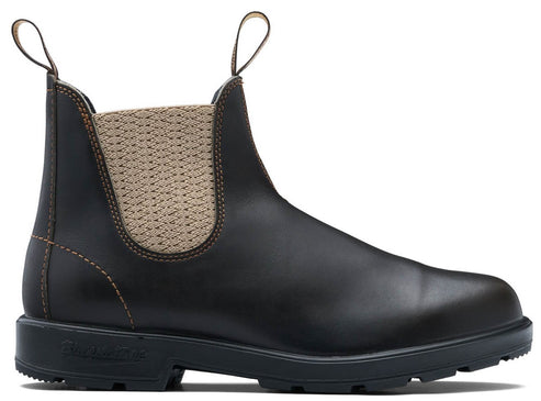 A dark brown leather Chelsea boot with tan elastic side panels and two nylon pull tabs, featuring visible contrast stitching and a thick, black, lugged rubber sole.
