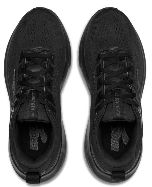 Top-down view of black running shoes, black laces, text "BEAST GTS 26" visible.