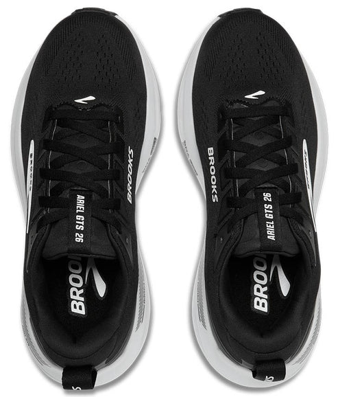 Top view of a pair of black running shoes with white soles and the text "ARIEL GTS 26" and "BROOKS" printed on the sides.