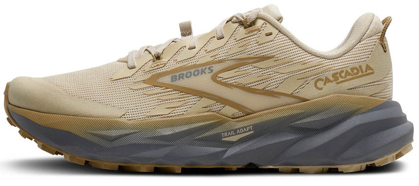 A tan running shoe with the word "BROOKS" and "CASCADIA" on the side, with a jagged gray and tan sole.