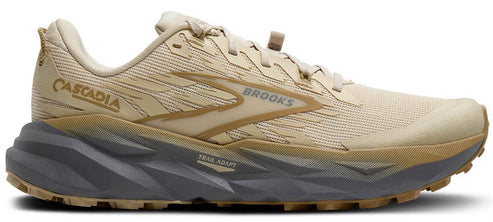 A tan-colored running shoe with the text "CASCADIA" and "BROOKS".