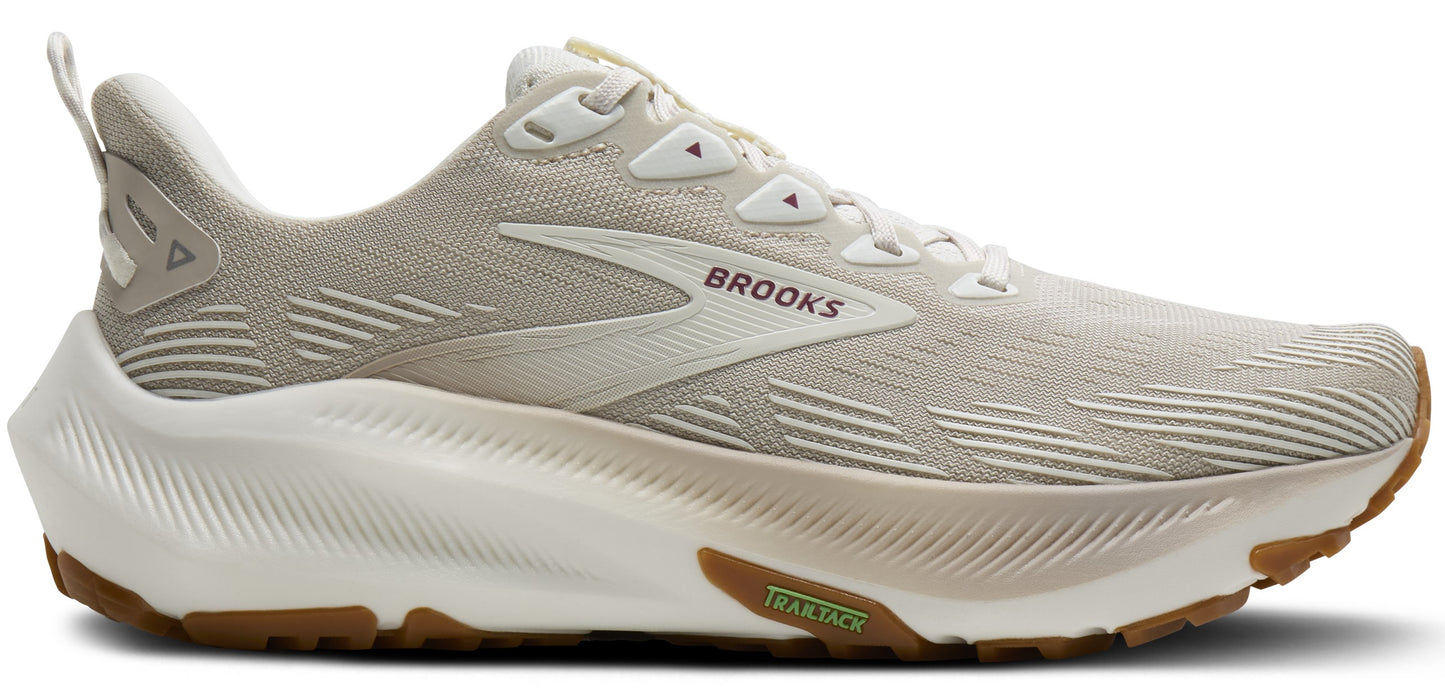 A tan running shoe with a thick white sole and brown tread.