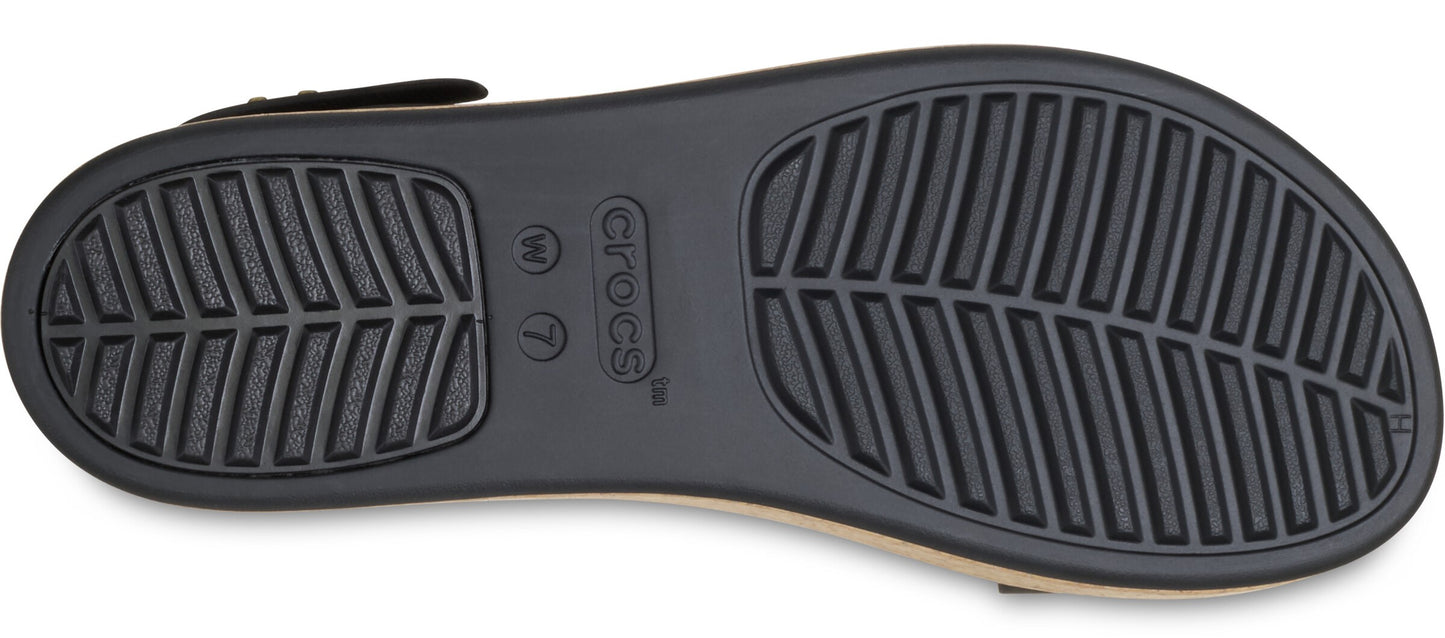 Shoe sole with prominent textured leaf-patterned treads and labeled with the brand name and size W 7.
