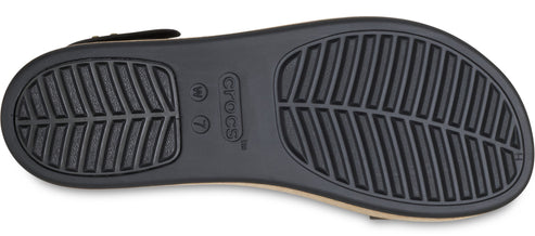 Shoe sole with prominent textured leaf-patterned treads and labeled with the brand name and size W 7.