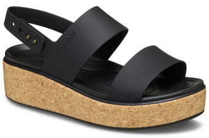 Black sandal with cork wedge heel and adjustable heel strap.