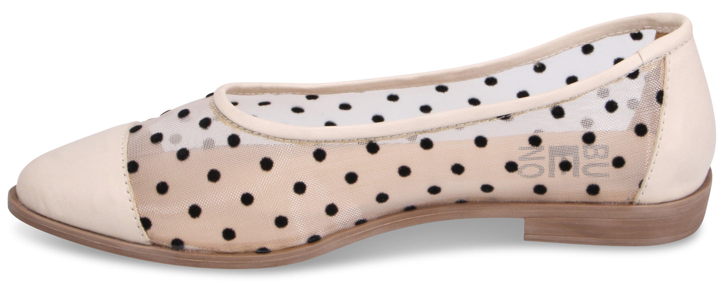 A beige flat shoe with black polka dots on the sides and toe.