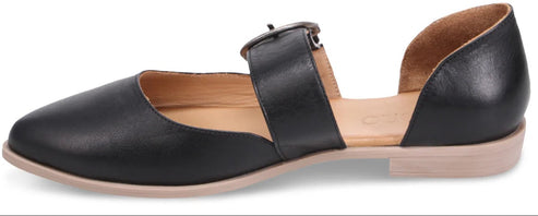 A black leather flat shoe with an ankle strap and buckle.