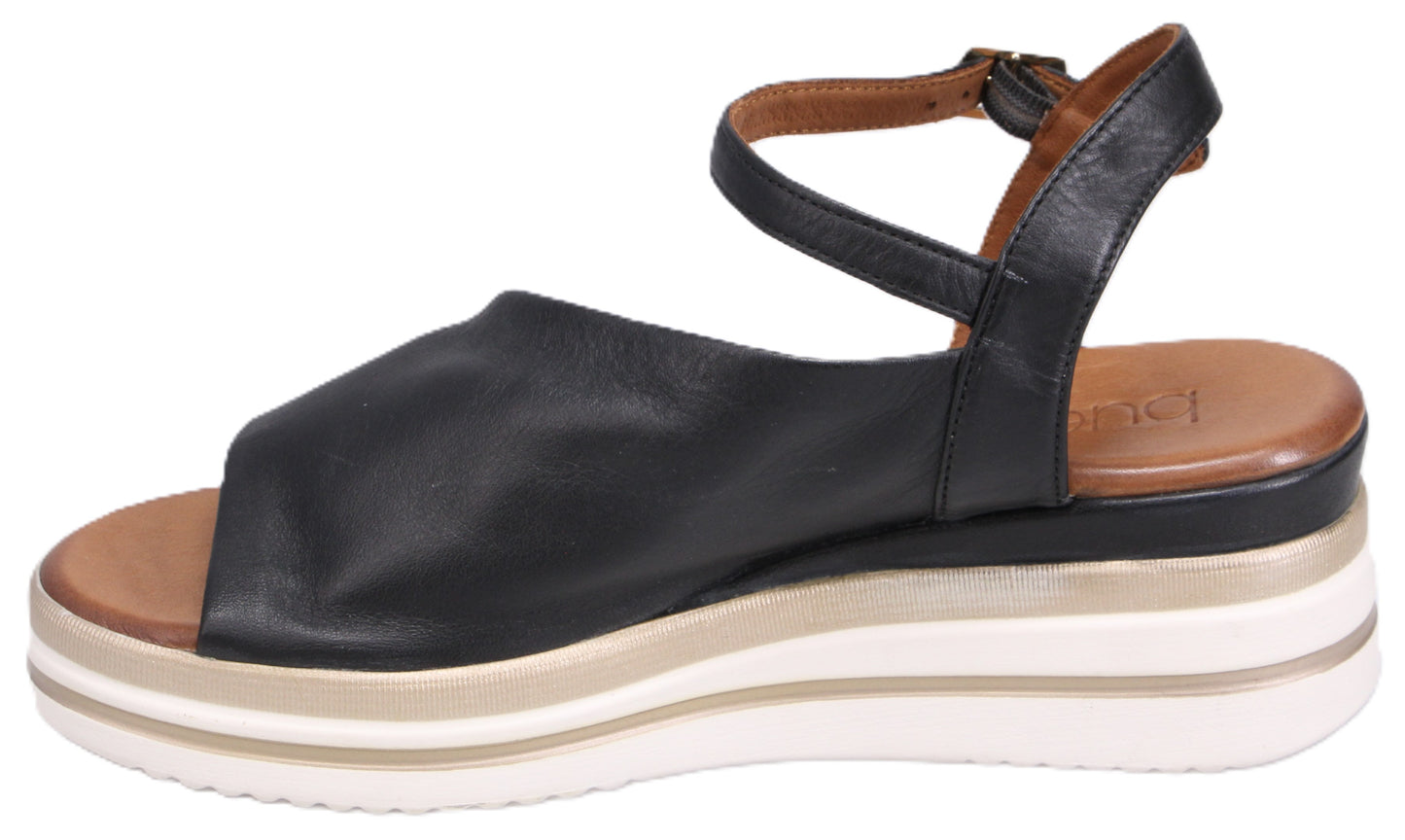 Black sandal with platform sole and ankle strap.