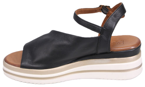 Black sandal with platform sole and ankle strap.