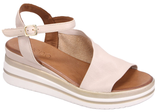 Beige sandal with an ankle strap and a layered white wedge sole.