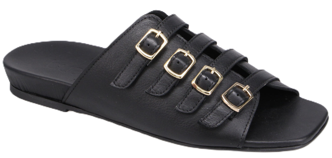 A black slide sandal featuring three straps, each adorned with a gold buckle.