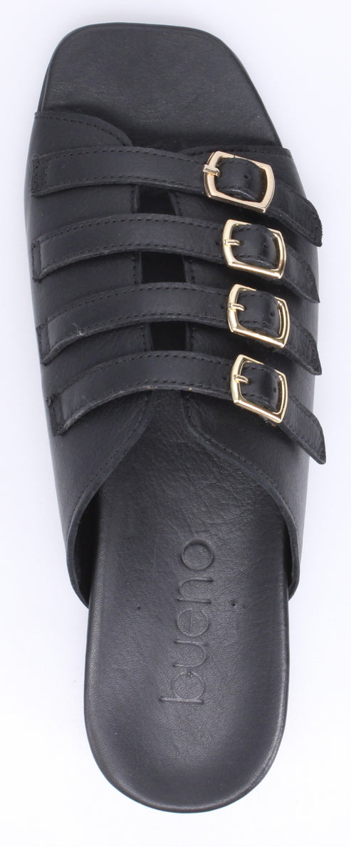 A black sandal with four straps that have gold buckles.