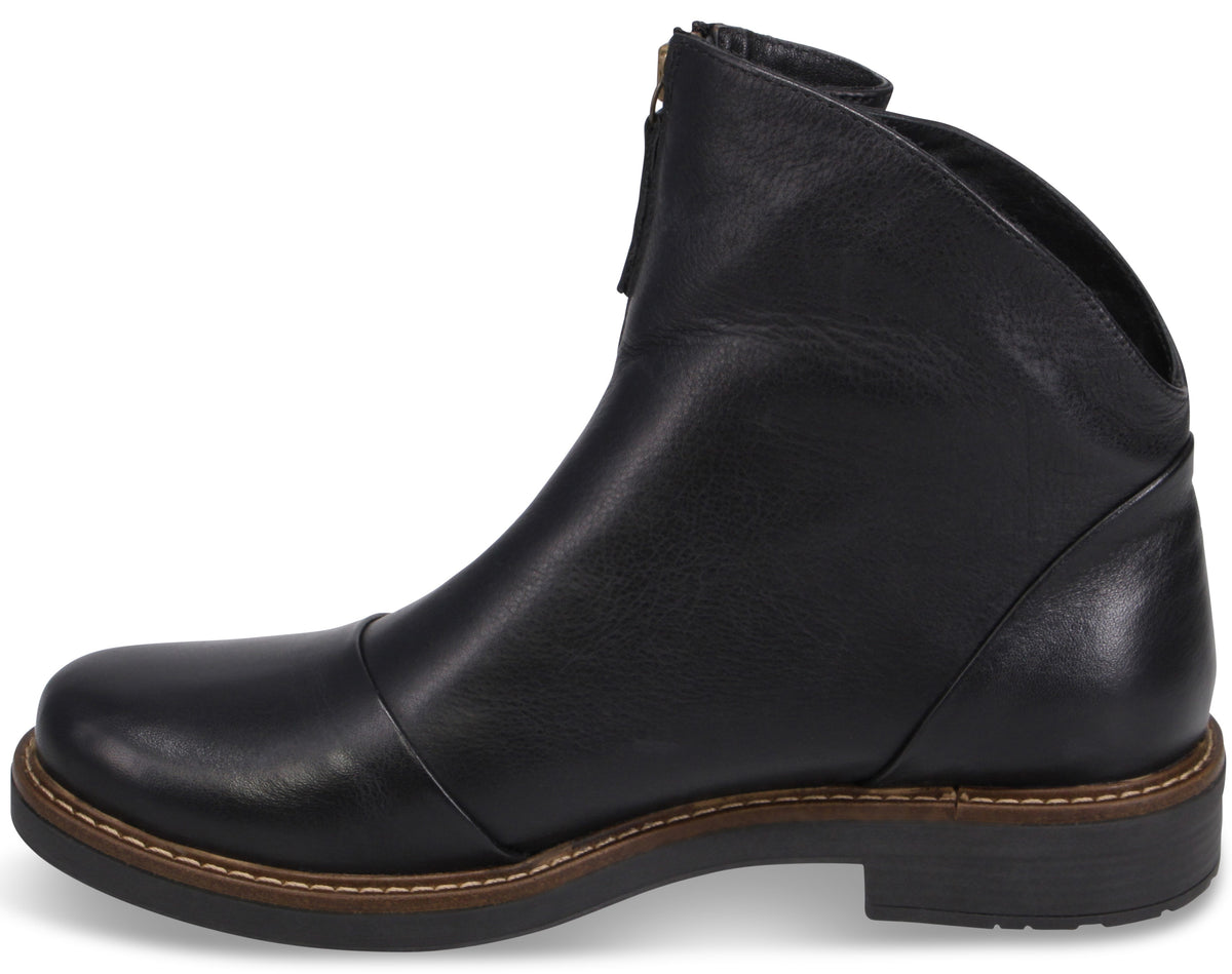 A black leather ankle boot with a rounded toe, a visible front zipper closure, and a low, stacked-look heel with tan stitching along the welt.