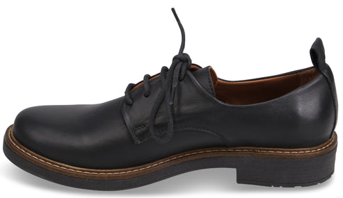 A black leather derby shoe with a tan welt, dark brown sole, matching black laces, and a pull tab on the heel.