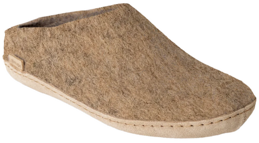 A close-up of a felt, low-cut, beige slipper.