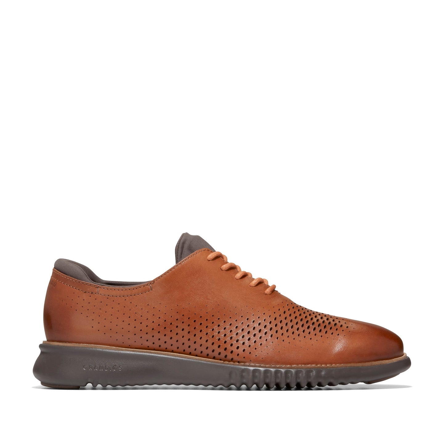Brown perforated dress shoe with a low profile.